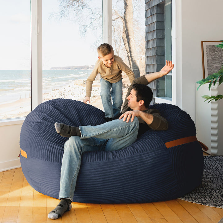 Kid playing on Big Joe Fuf XL Foam Beanbag Lounger Midnight Blue Corded Plush #color_midnight-blue-corded-plush