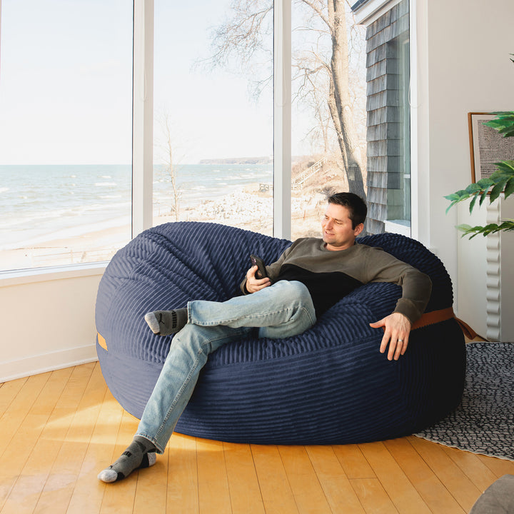 Man on Big Joe Fuf XL Foam Beanbag Lounger Midnight Blue Corded Plush #color_midnight-blue-corded-plush