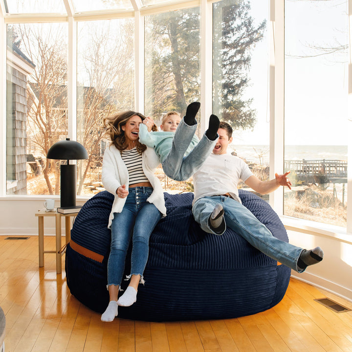 Family jumping into Fuf XXL Foam Beanbag  Midnight Blue Corded Plush #color_midnight-blue-corded-plush