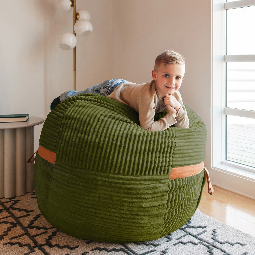 boy relaxing on the medium Fuf #color_moss-green-corded-plush