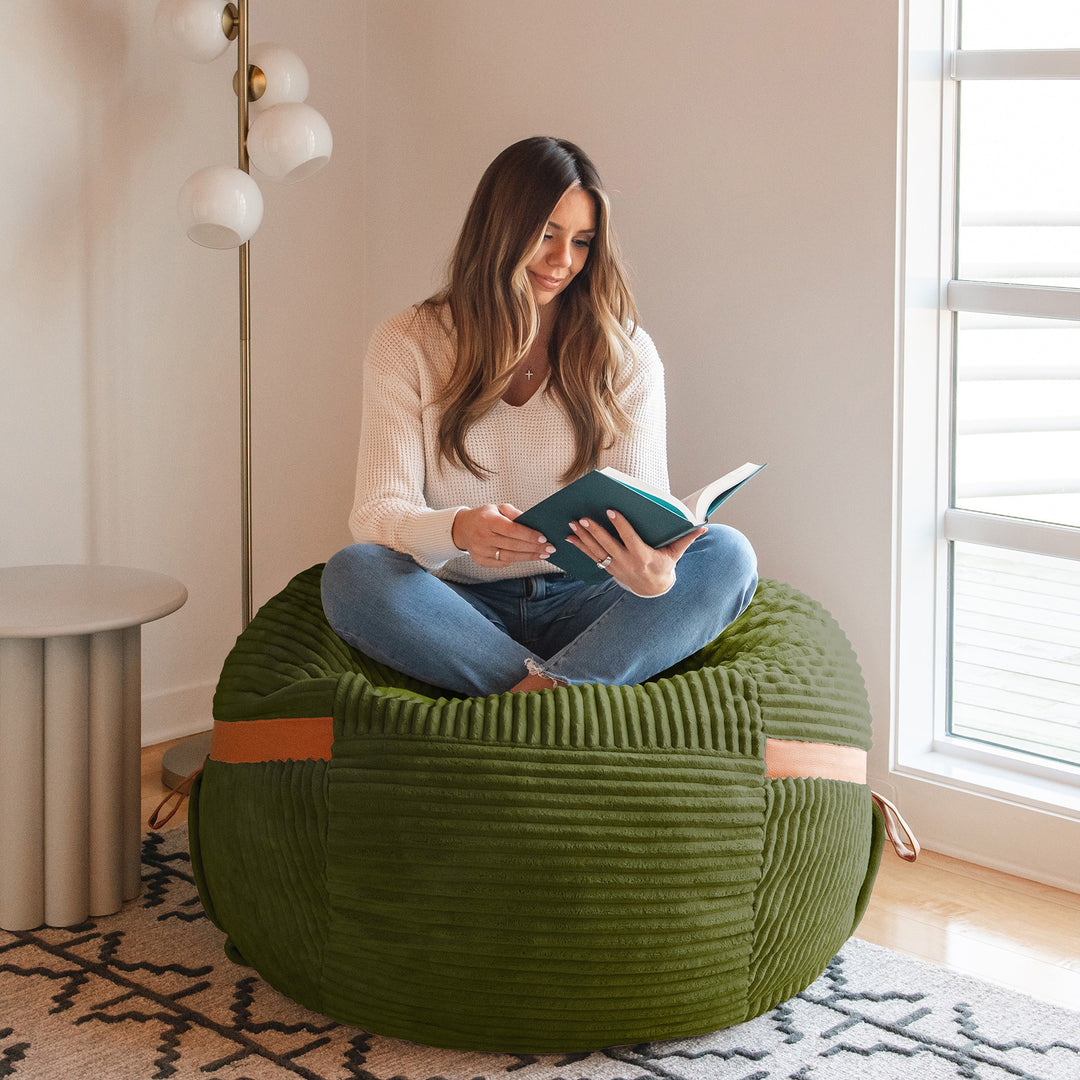 Woman reading on the fuf Medium #color_moss-green-corded-plush