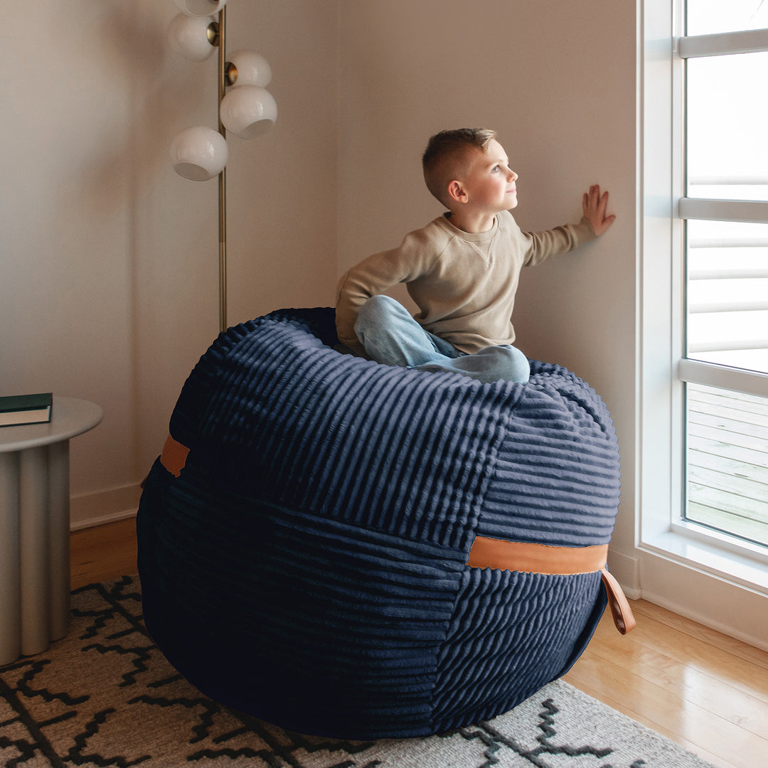 boy playing on Fuf Medium Foam-Filled Bean Bag Chair #color_midnight-blue-corded-plush