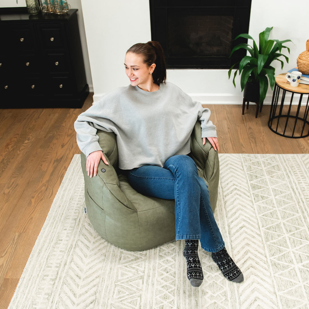 Woman Relaxing in Milano with Vibe in Olive Green vegan leather #color_olive-green-vegan-leather