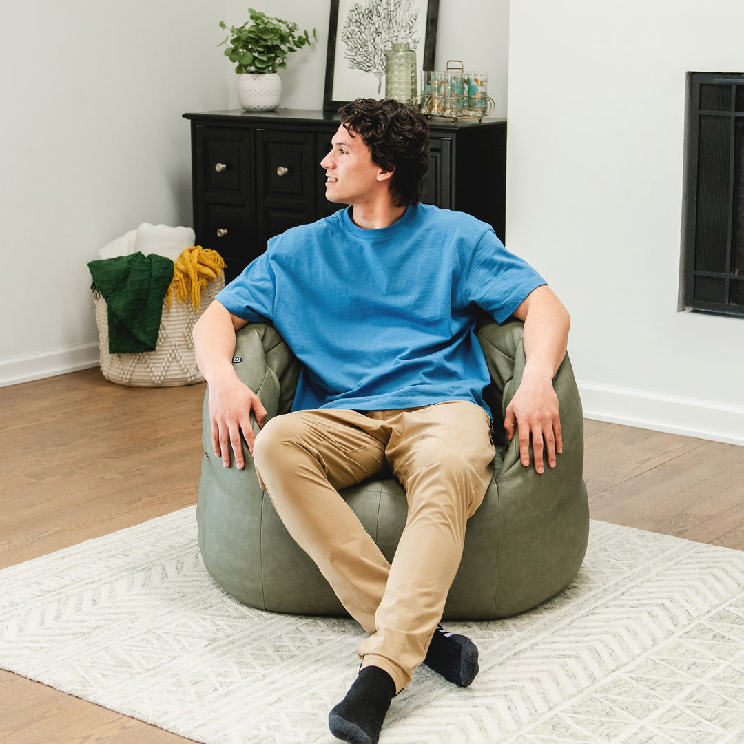 Man chilling in Milano with Vibe in Olive Green vegan leather #color_olive-green-vegan-leather