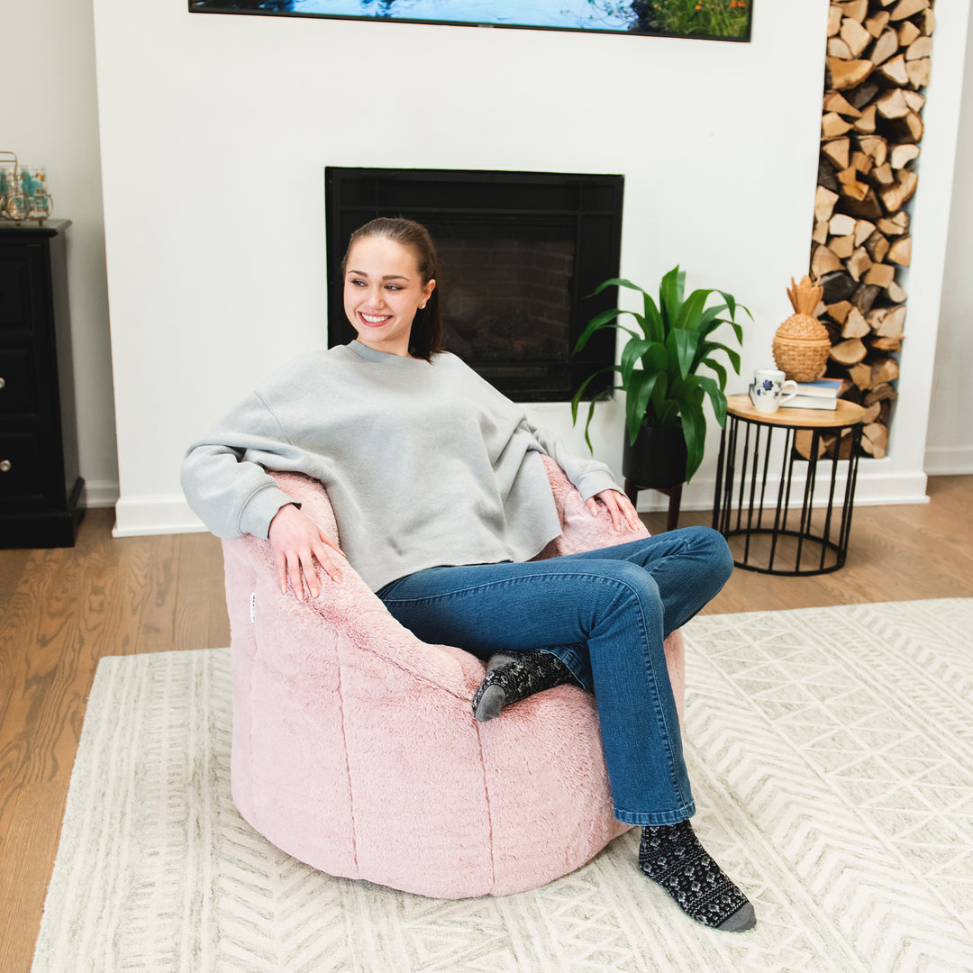 Girl relaxing on the Milano Bean Bag Chair in Pink Blush Plushie Fabric #color_pink-blush-plushie