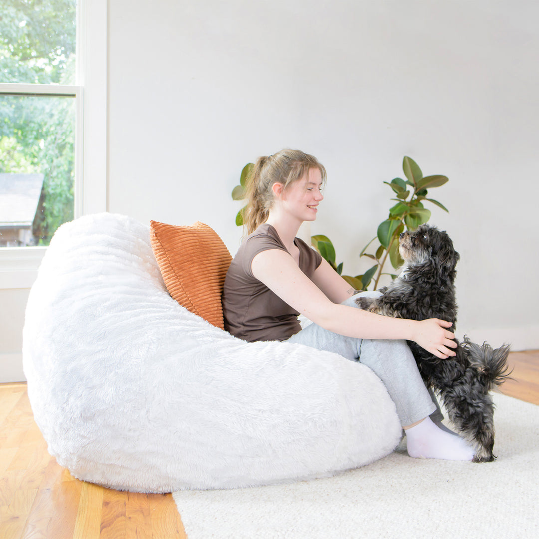 Lotus Foam Filled Bean Bag Chair girl playing with dog #color_ivory-short-shag