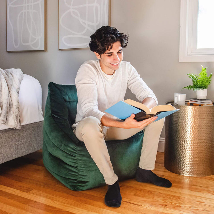 Green Aurora bean bag chair guy relaxing #color_deep-emerald-velvet