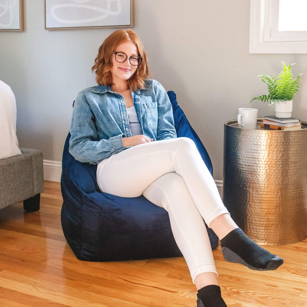Aurora Bean Bag Chair woman relaxing #color_deep-navy-velvet