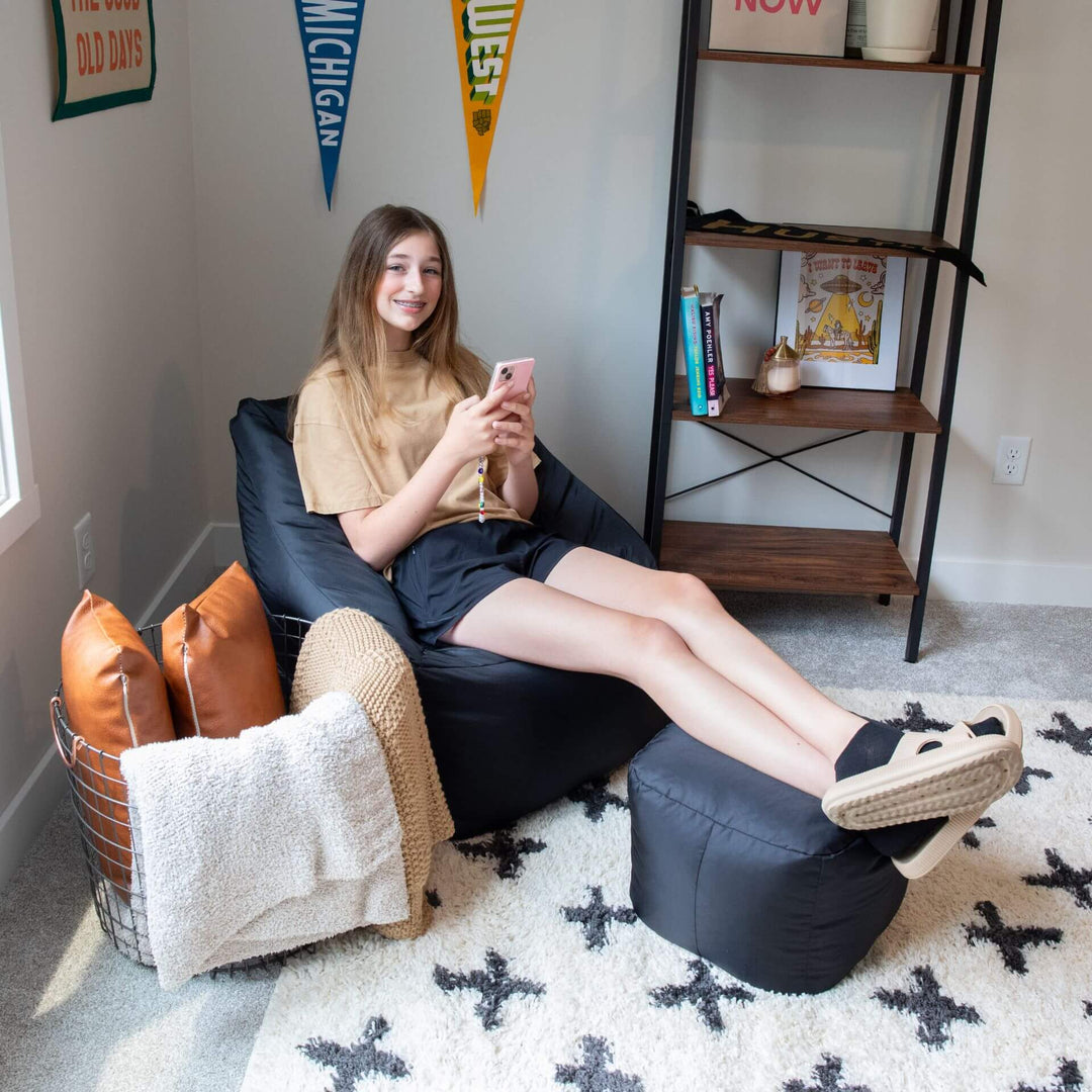 Girl sitting on bean bag chair in room #color_black-smartmax