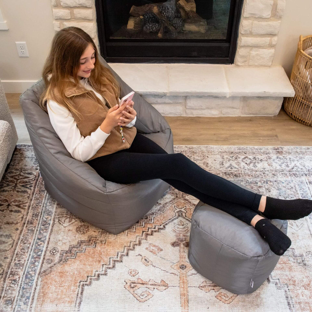 Woman in bean bag chair with ottoman relaxing #color_graphite-smartmax