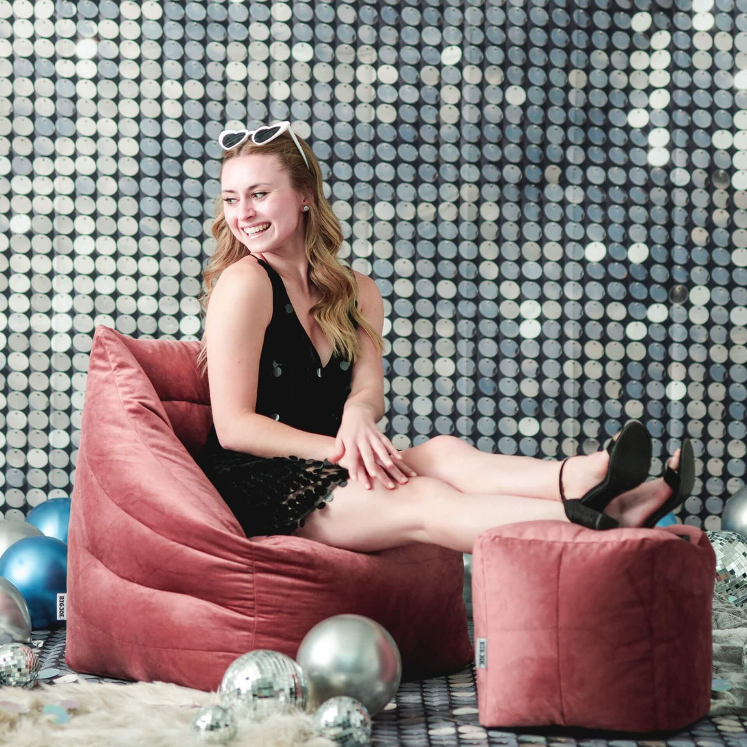 Woman sitting on bean bag chair at party #color_toasted-mauve-velvet