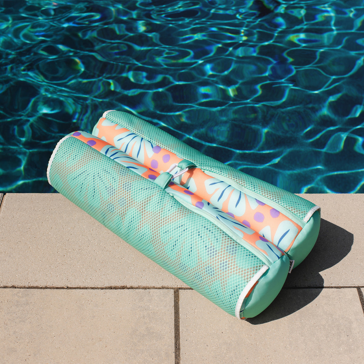 Mesh hammock pool float next to a pool