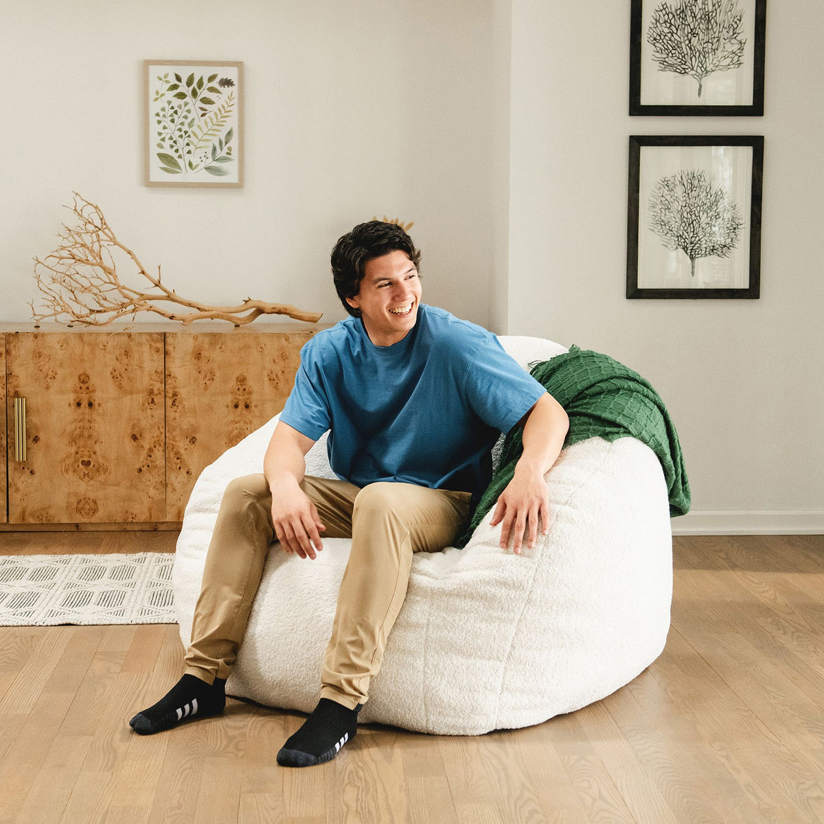 Man getting out of a white chair in the living room