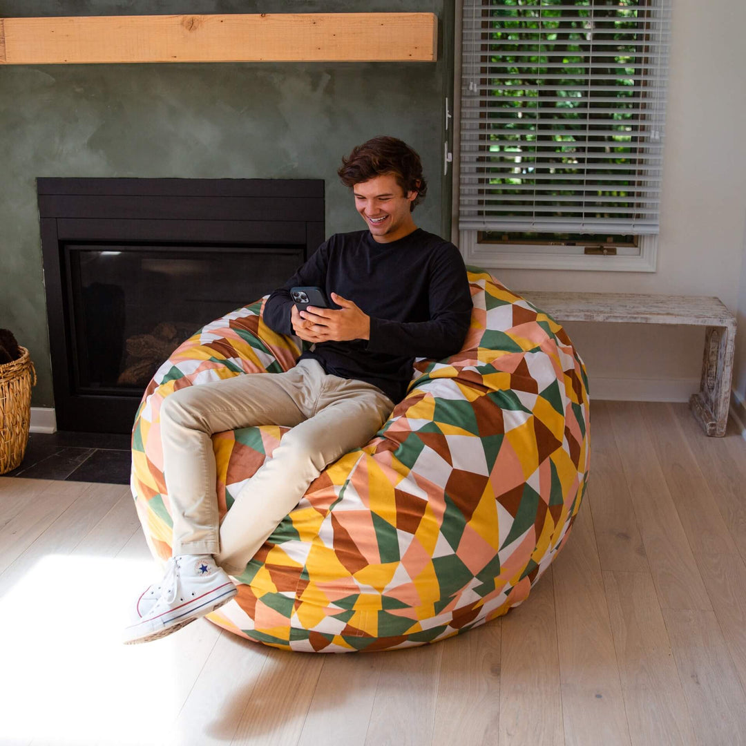 Man playing games in Fuf large retro beanbag chair #color_retro-geo-plush