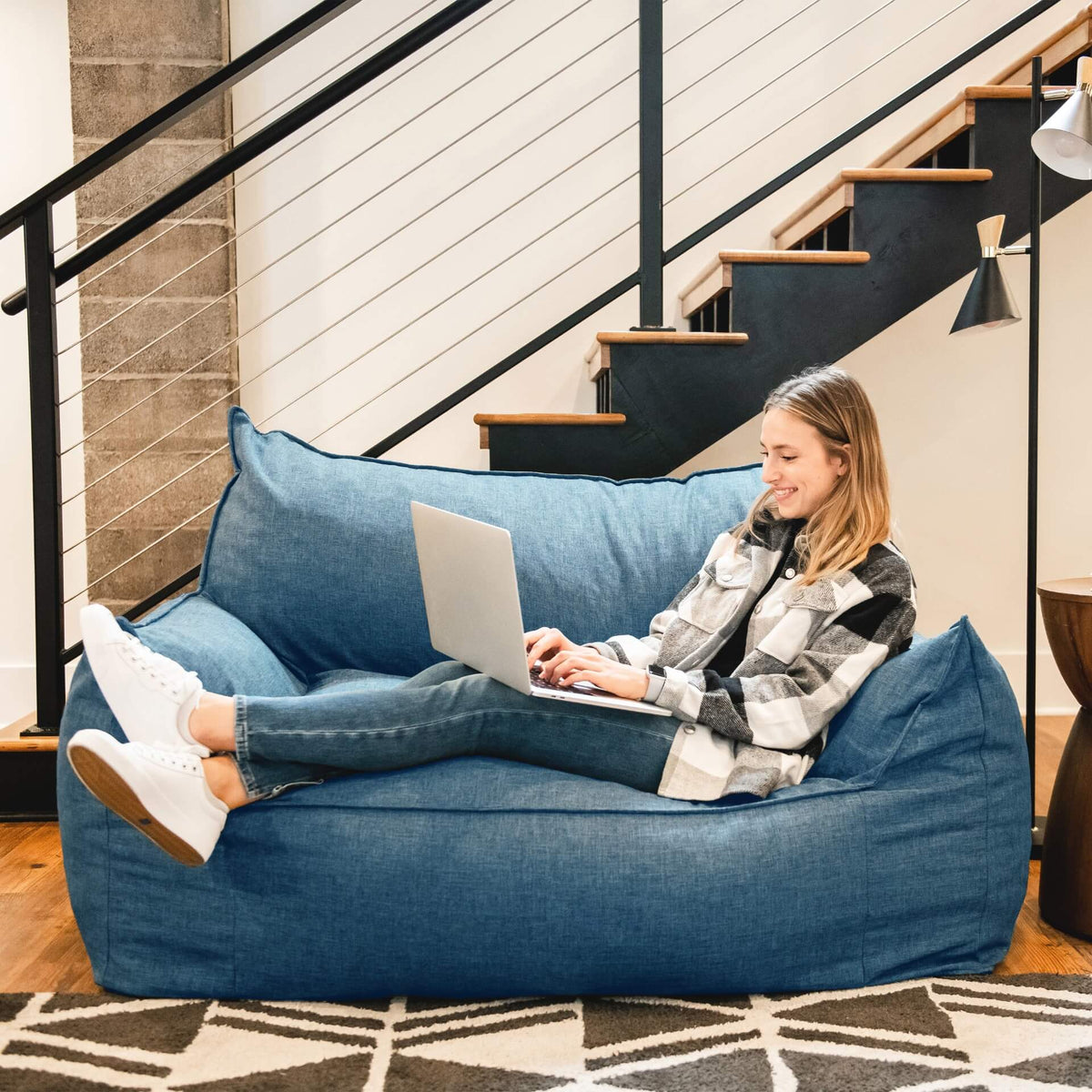 Blue Imperial Fufton Loveseat woman relaxing on computer