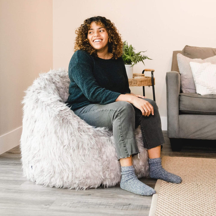 Milano Bean Bag Chair  woman relaxing in living room #color_gray-shag