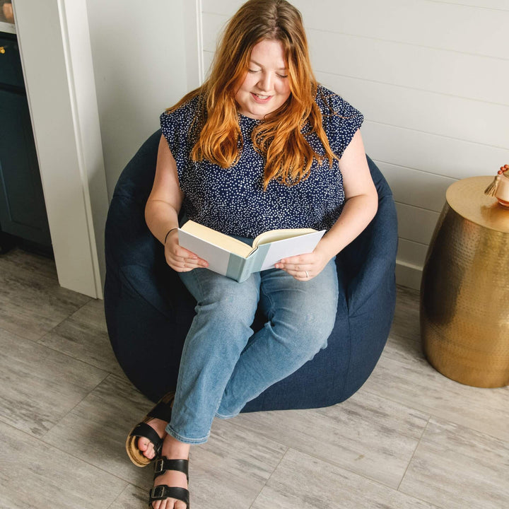 Milano Adult Beanbag Chair woman reading book #color_cobalt-lenox