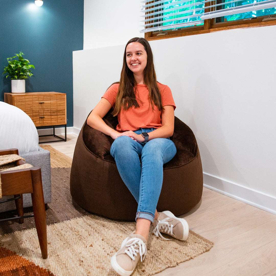 Girl relaxing in room on marmit beanbag chair #color_cocoa-lenox