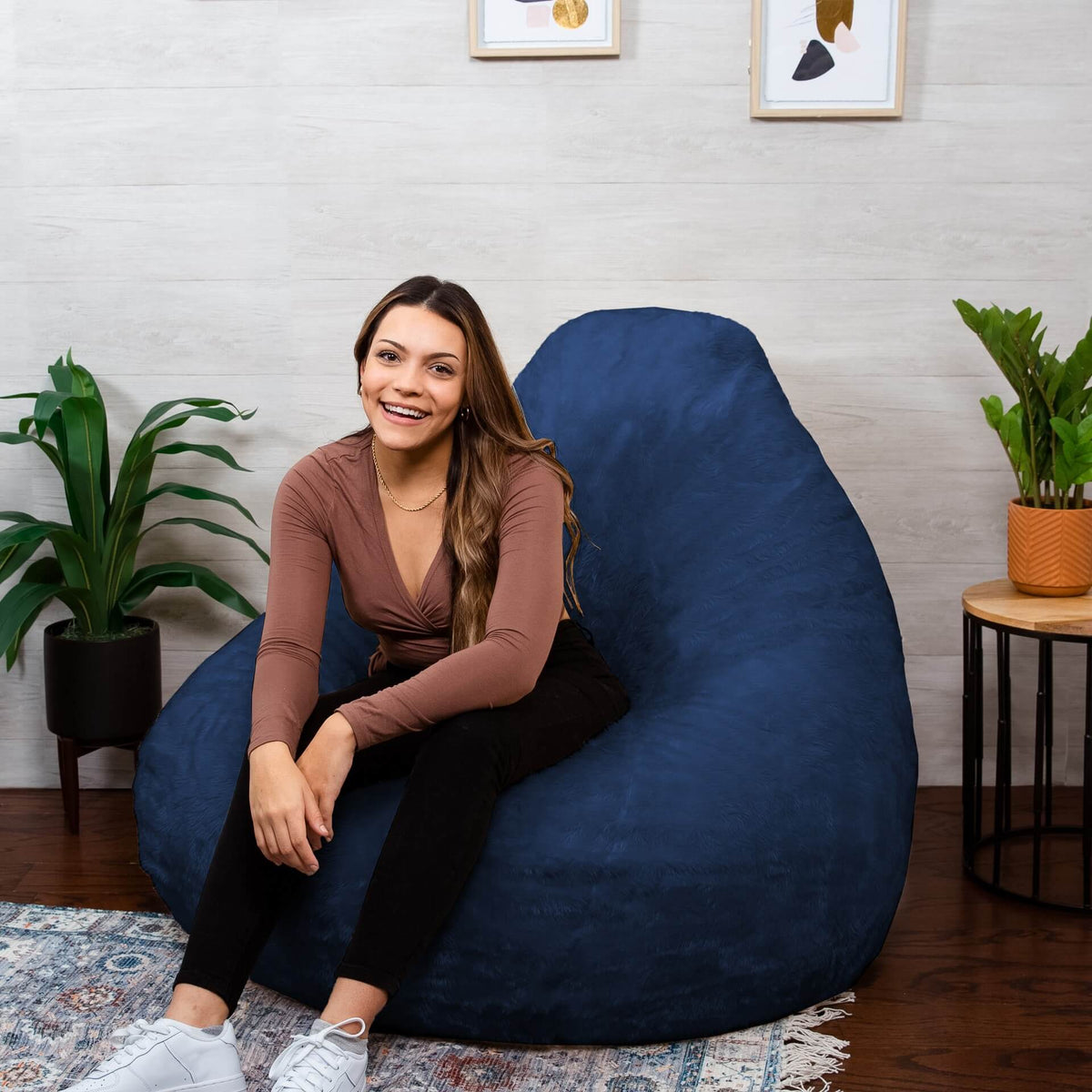 woman on lotus beanbag chair in teardrop shape #color_navy-short-shag