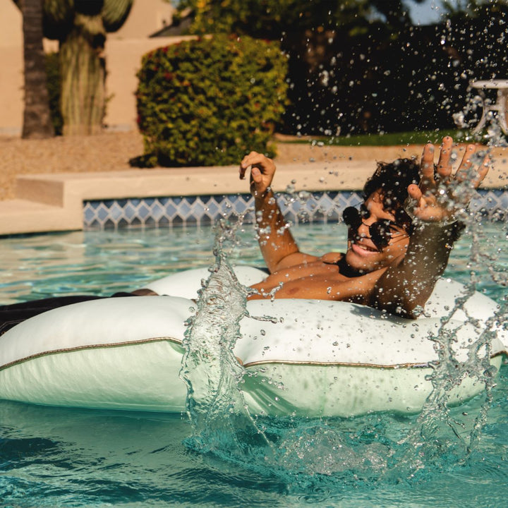 Man Relaxing and Playing on Sand Dollar Pool Float #color_tea-green