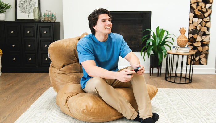 Man playing video game in a Roma Bean Bag Chair
