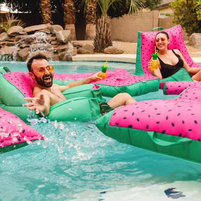 Man and women floating in a pool