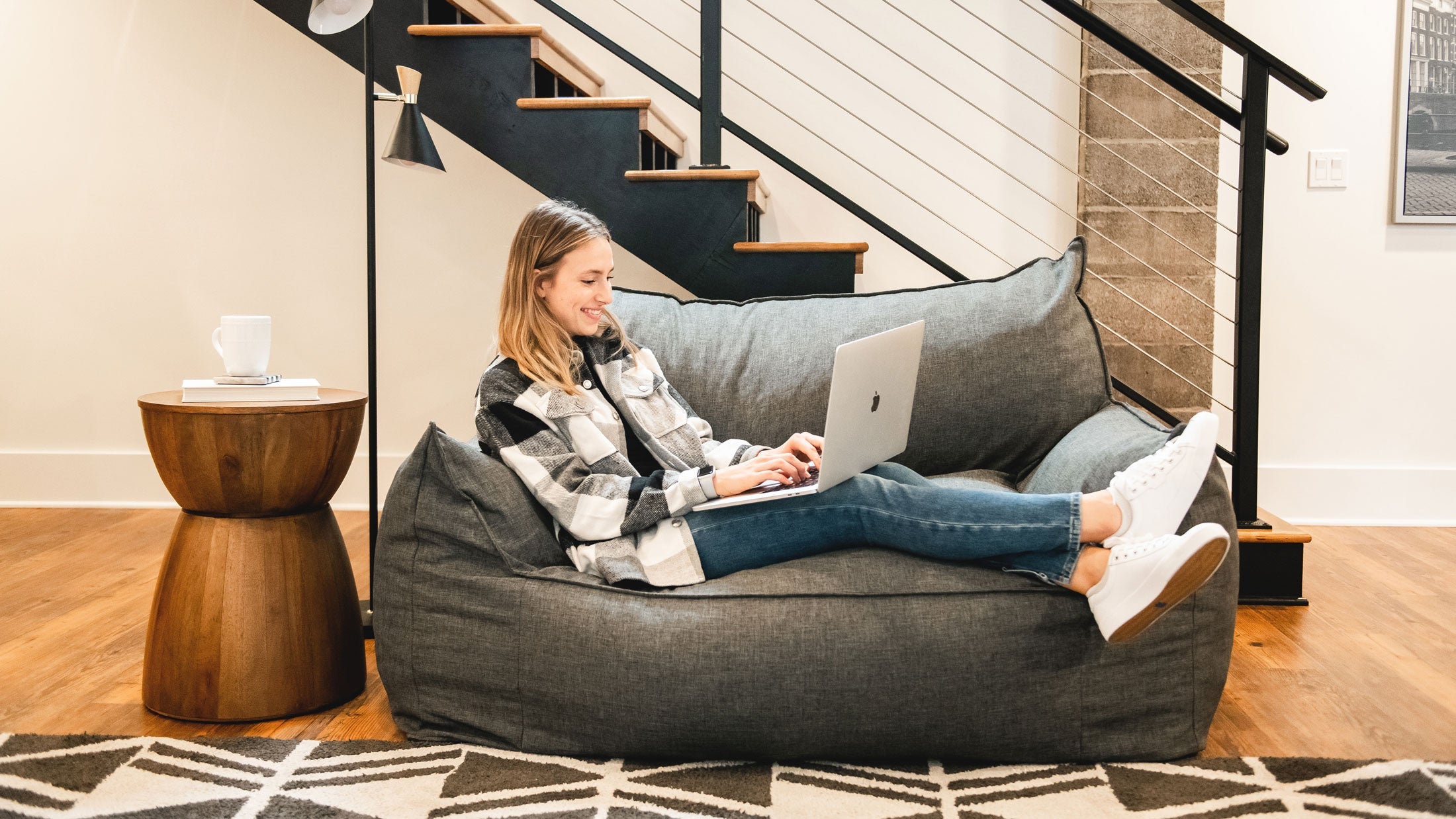 Woman relaxing on the imperial futon in the living room