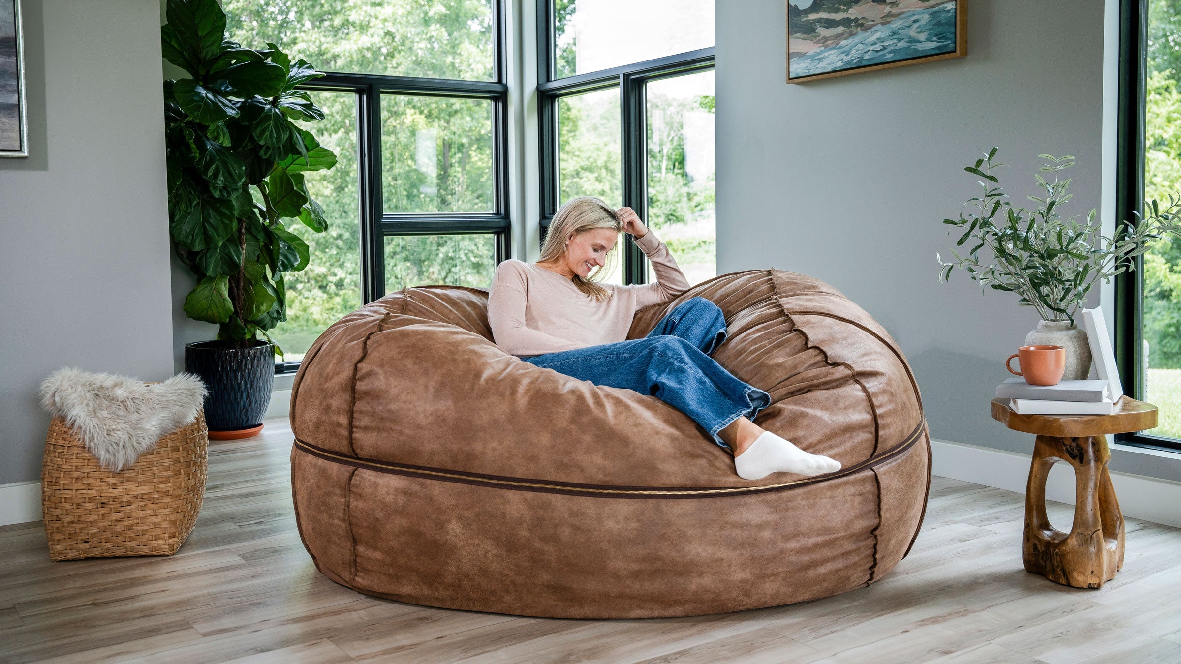 Woman lounging on the Fuf XXL oversized bean bag chair