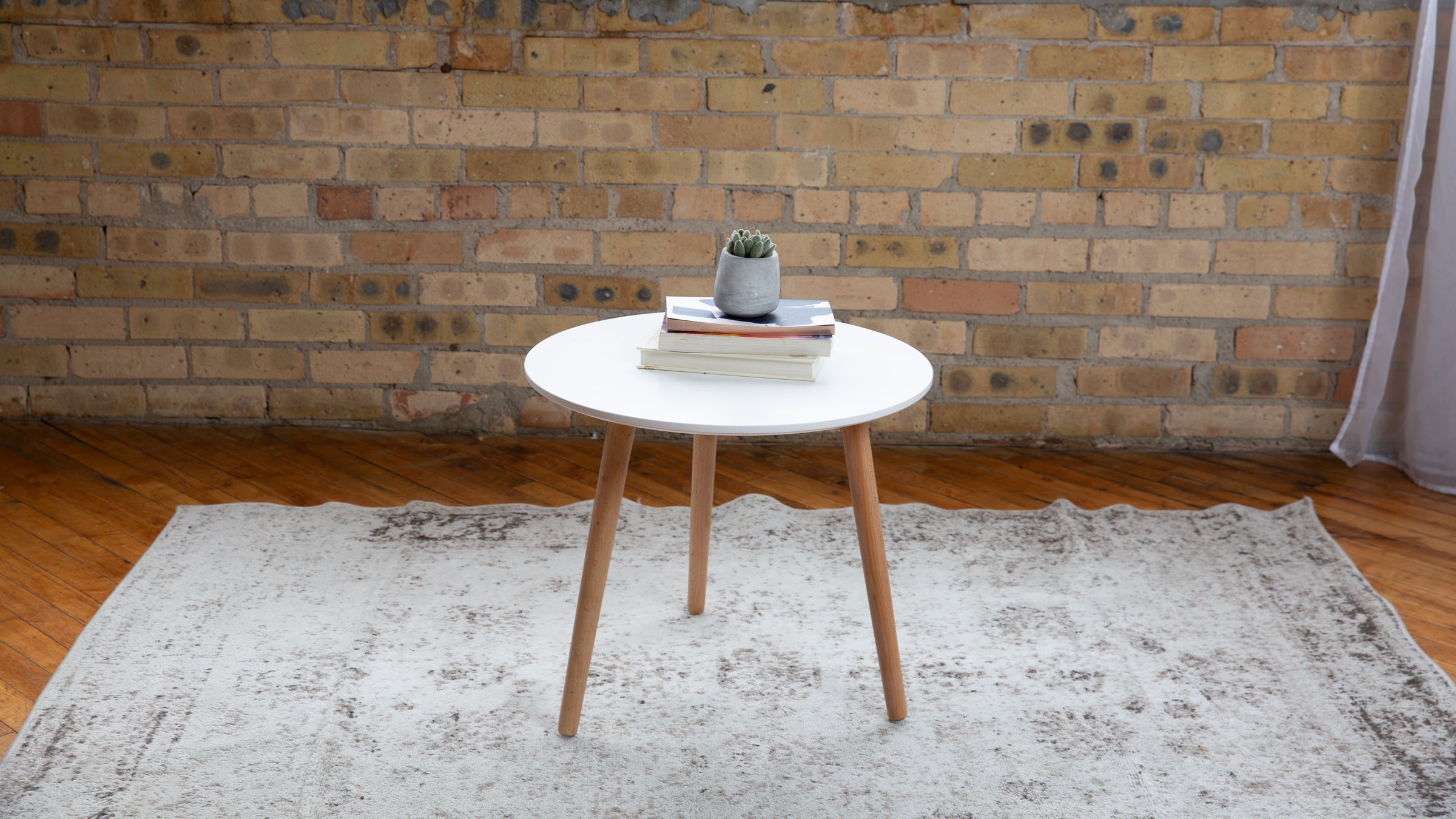 living room end table with books sitting on a rug inside