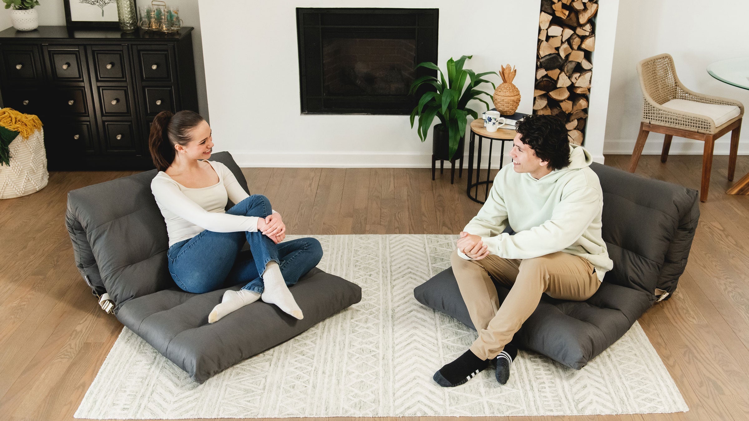 Convertible lounge chairs with couple sitting in living room
