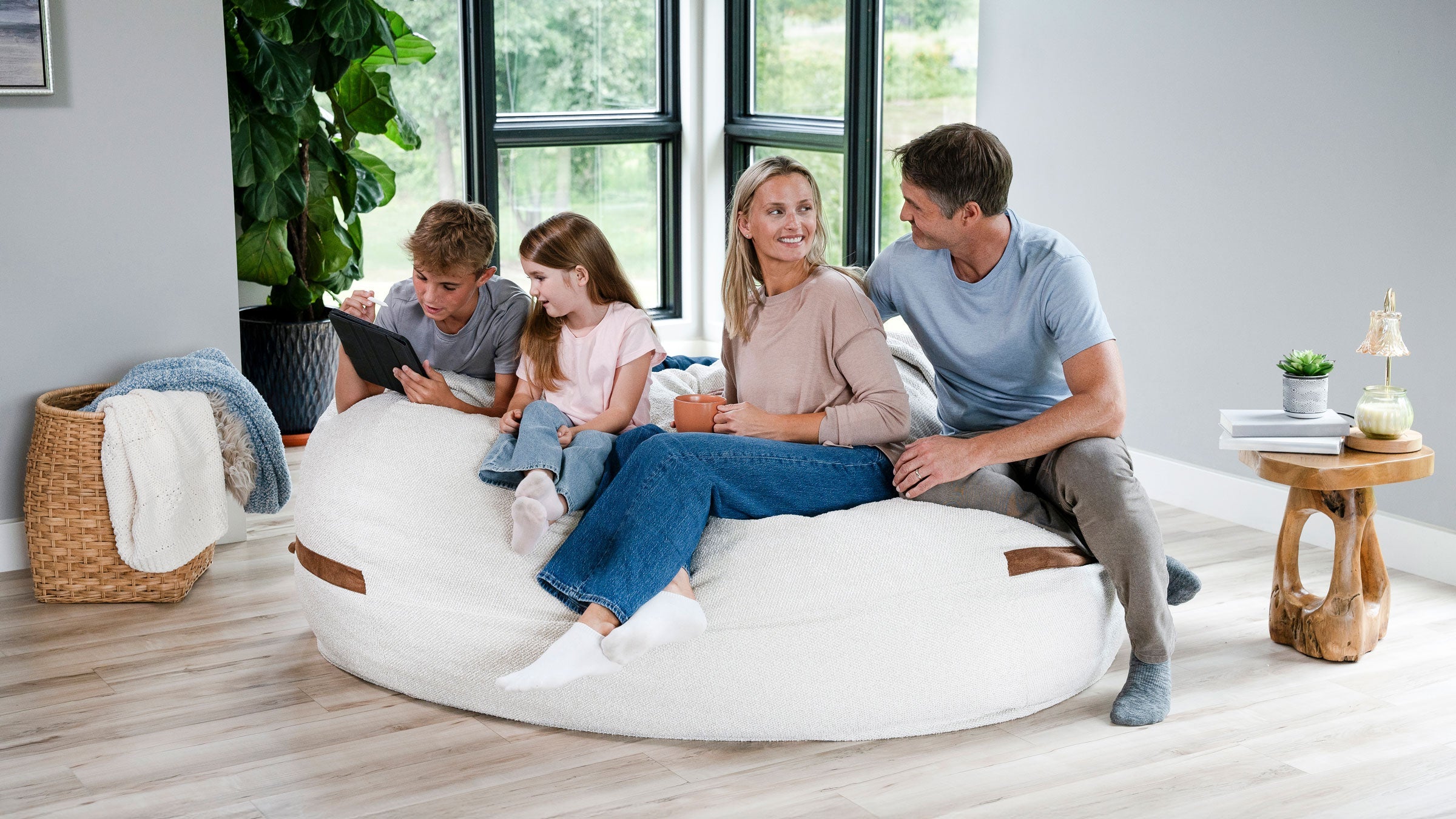 family relaxing on a Fuf XXL oversized bean bag lounger in the livingroom