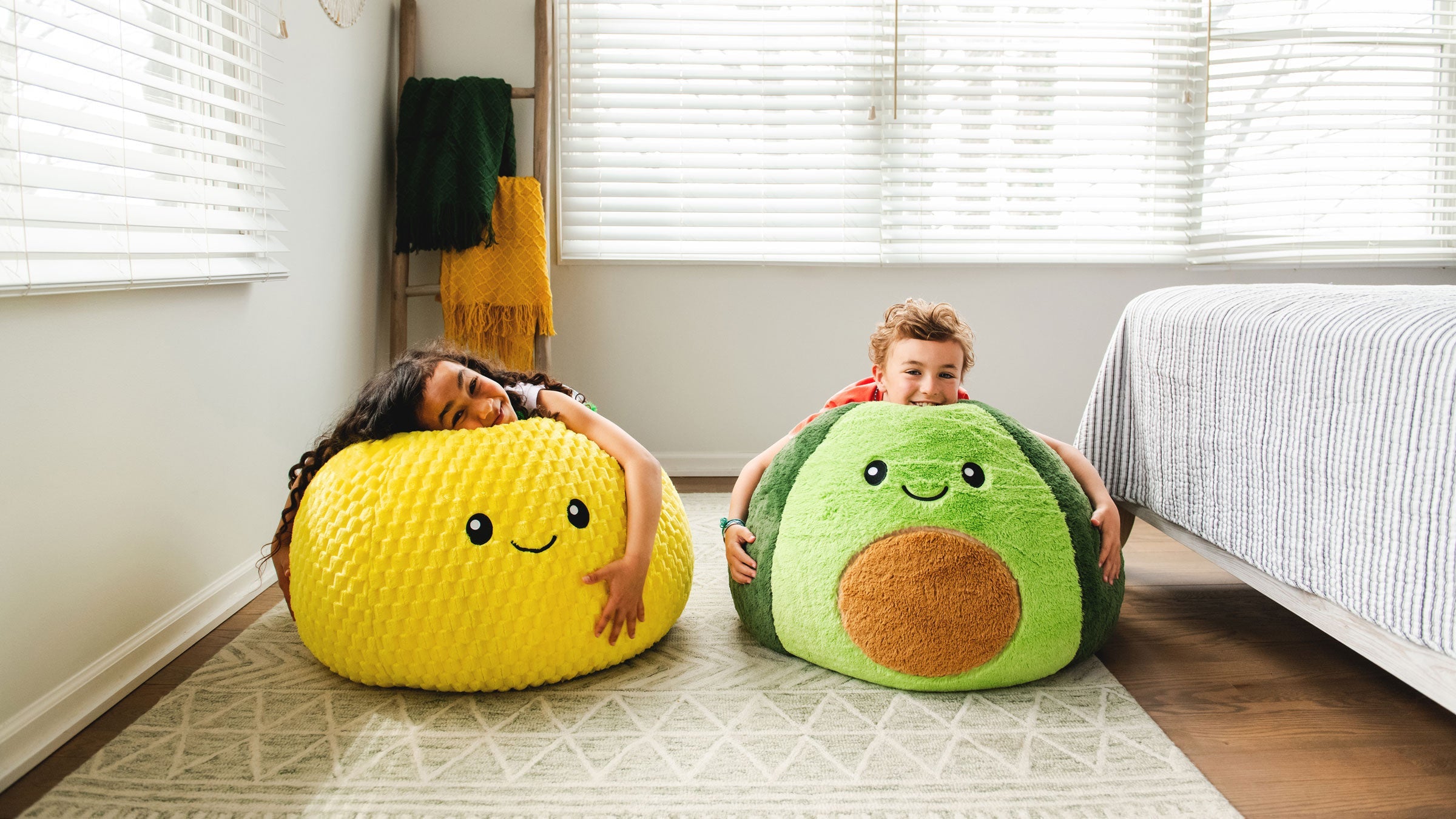 Shop chairs & floats under $100, girl holding the avocado plushipals bean bag chair