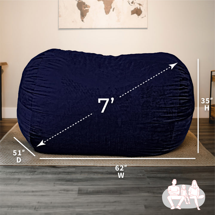 Navy bean bag with dimensions labeled on a wooden floor. #color_midnight-plush
