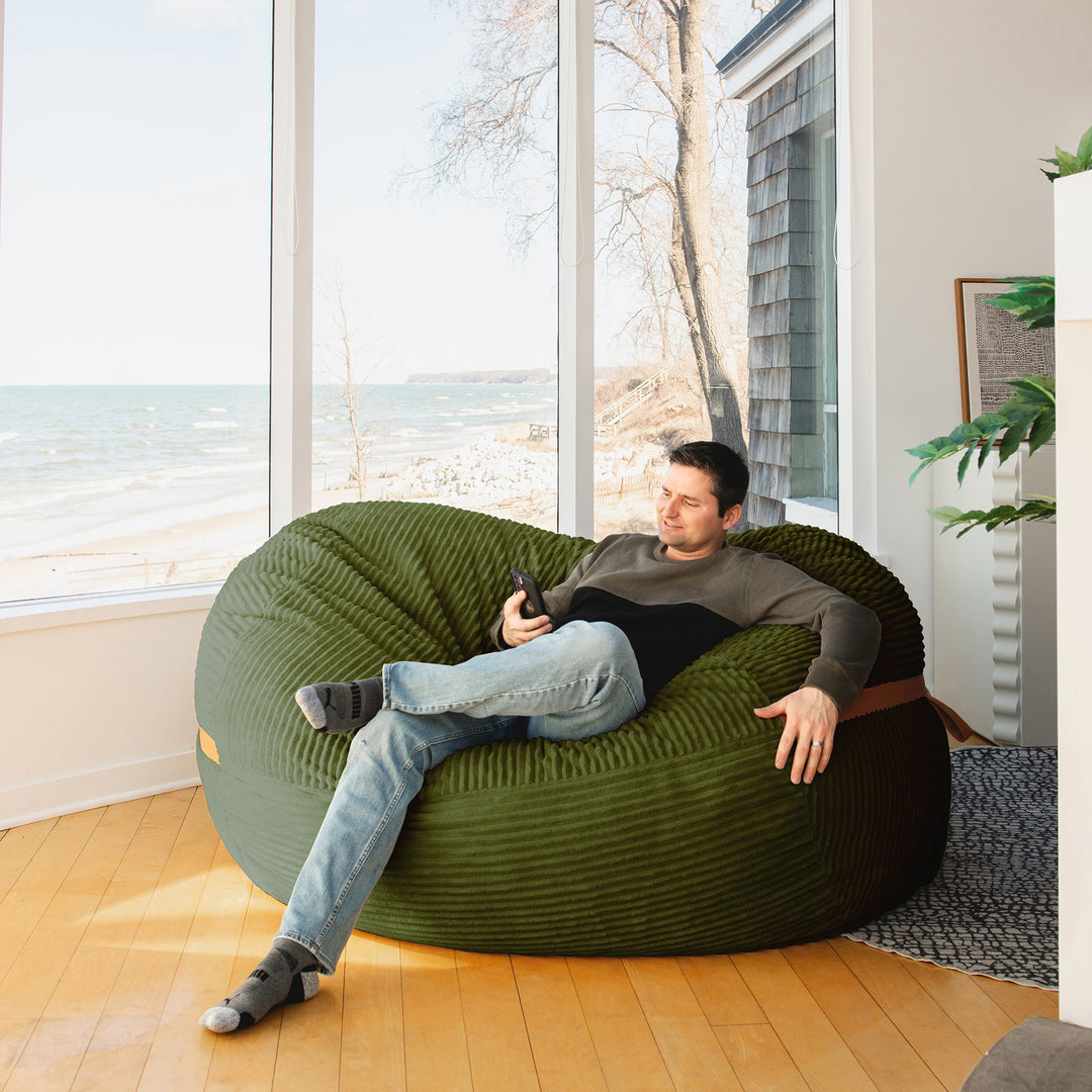 man enjoying view Big Joe Fuf XL Foam Beanbag Lounger Moss Green Corded Plush #color_moss-green