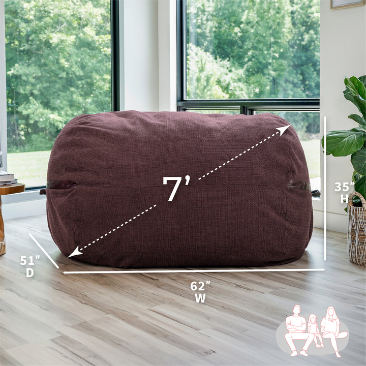 Merlot bean bag chair with dimensions labeled in a room with large windows. #color_merlot-cloudweave