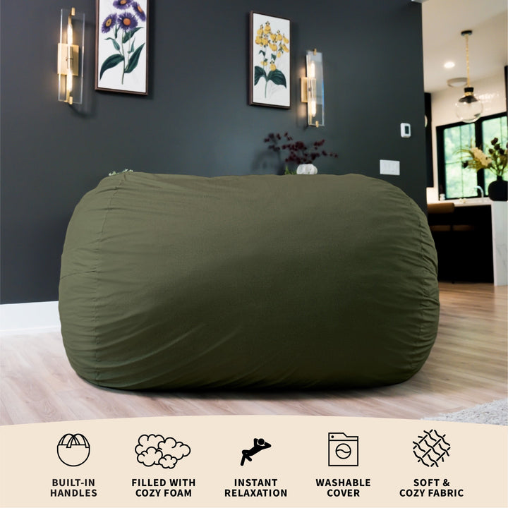 Green bean bag chair in a room with dark walls and light wood flooring. #color_forest-green-velveteen