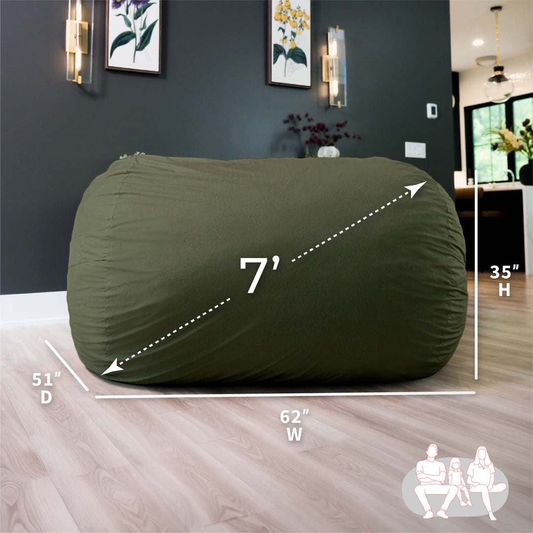 Green bean bag chair with dimensions labeled in a room setting #color_forest-green-velveteen
