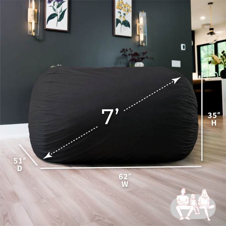 Black bean bag chair with dimensions labeled in a living room setting #color_black-brushed-denim