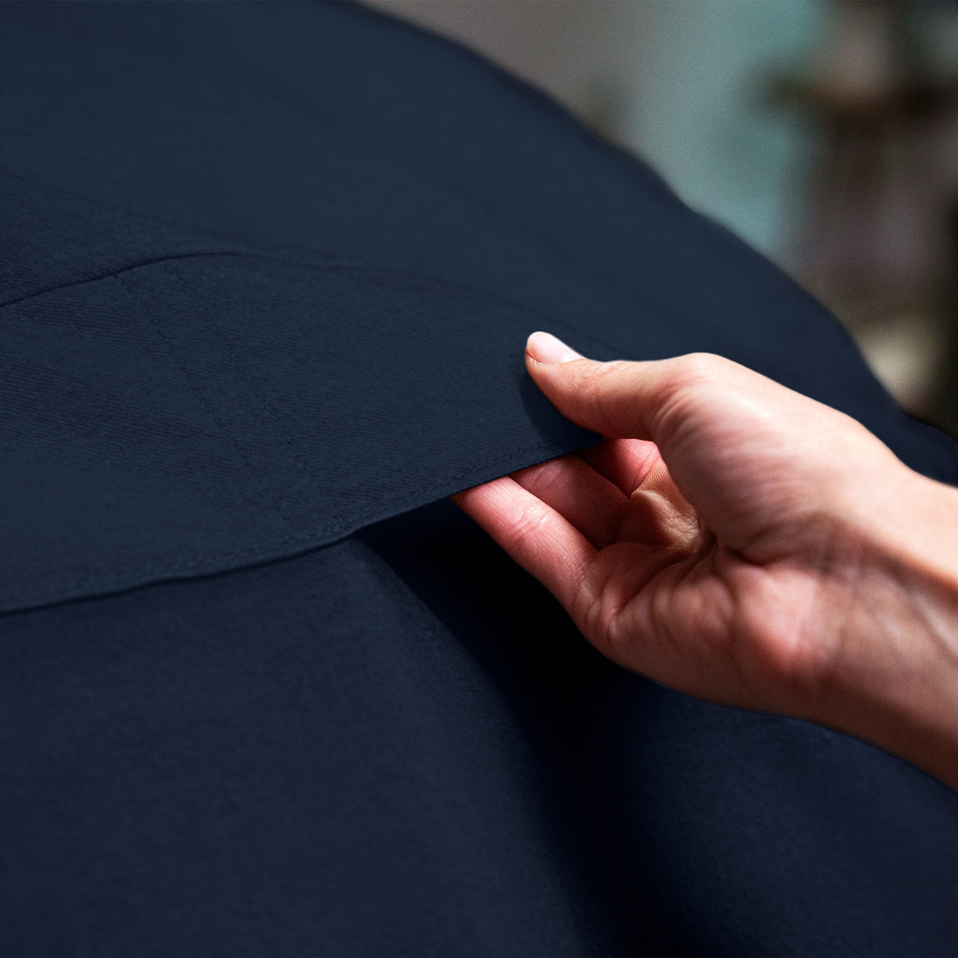 Hand holding a piece of dark blue fabric #color_cobalt-brushed-denim