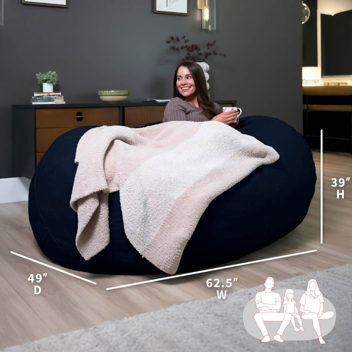 Large bean bag chair with a blanket, dimensions displayed, in a room setting. #color_cobalt-brushed-denim