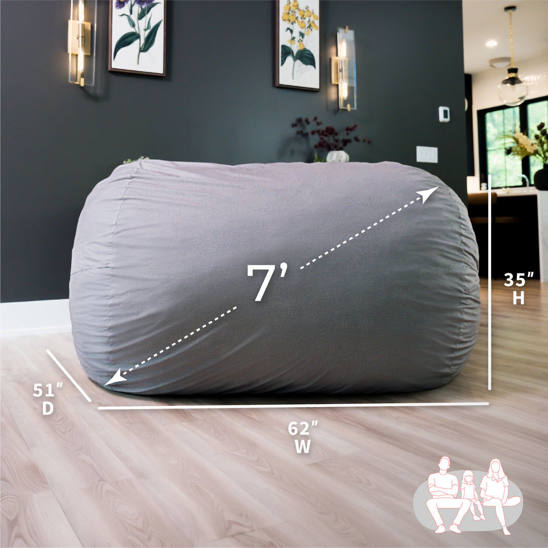 Gray bean bag chair with dimensions labeled in a room setting #color_fog-brushed-denim