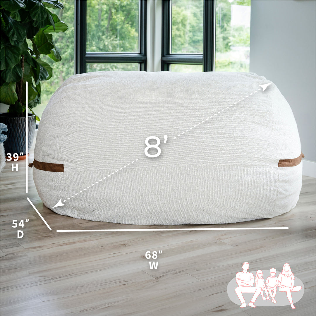 White bean bag chair with dimensions on a wooden floor #color_sandstone-textured-boucle