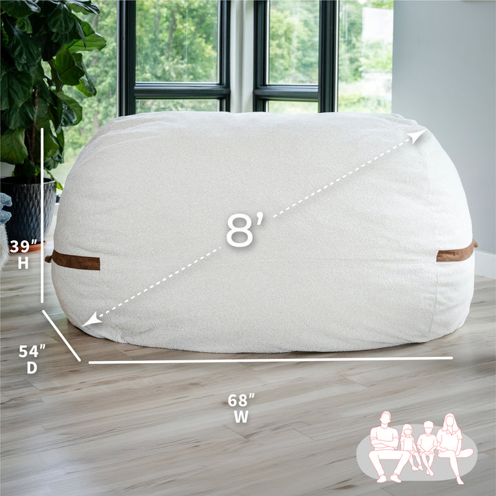 White bean bag chair with dimensions on a wooden floor #color_sandstone-textured-boucle