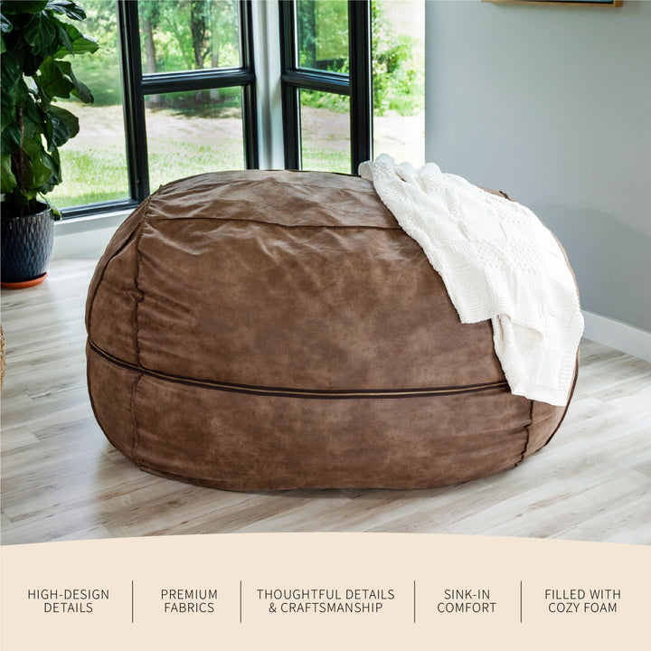 Brown bean bag chair with a white blanket on a wooden floor near a window with greenery outside. #color_coffee-soft-vegan-leather