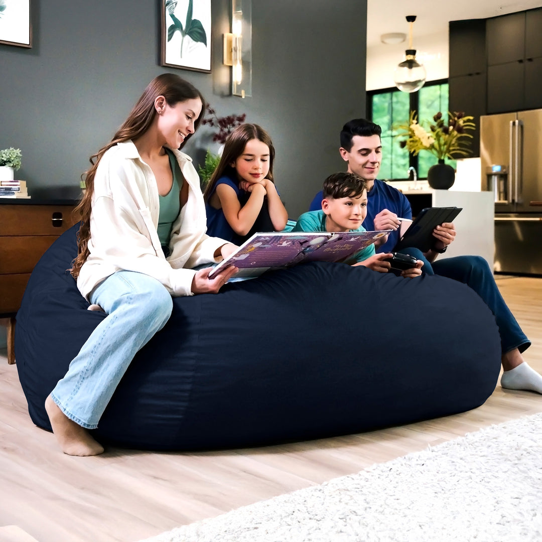 Family sitting on a large navy bean bag in a modern living room. #color_cobalt-brushed-denim