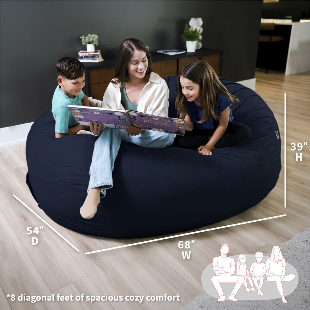 Woman and two children sitting on a navy bean bag reading a book, with measurements displayed. #color_cobalt-brushed-denim