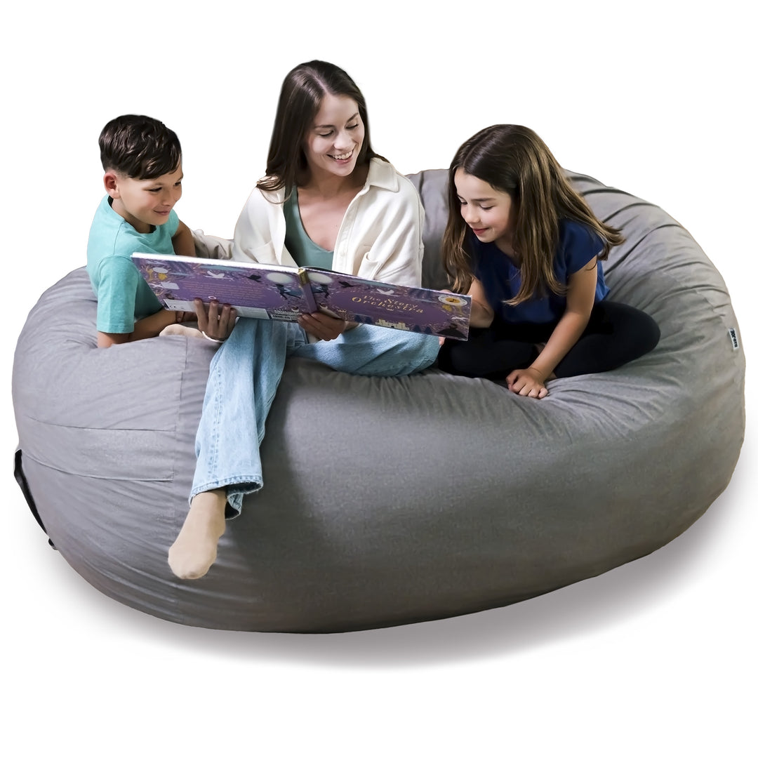 Woman reading a book to two children on a large gray bean bag chair. #color_fog-brushed-denim
