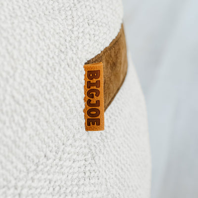 Close-up of a Big Joe logo on a textured white boucle beanbag  