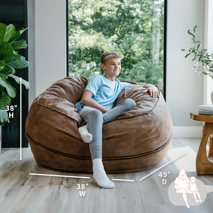 Child sitting on a large brown bean bag chair with dimensions displayed #color_coffee-soft-vegan-leather