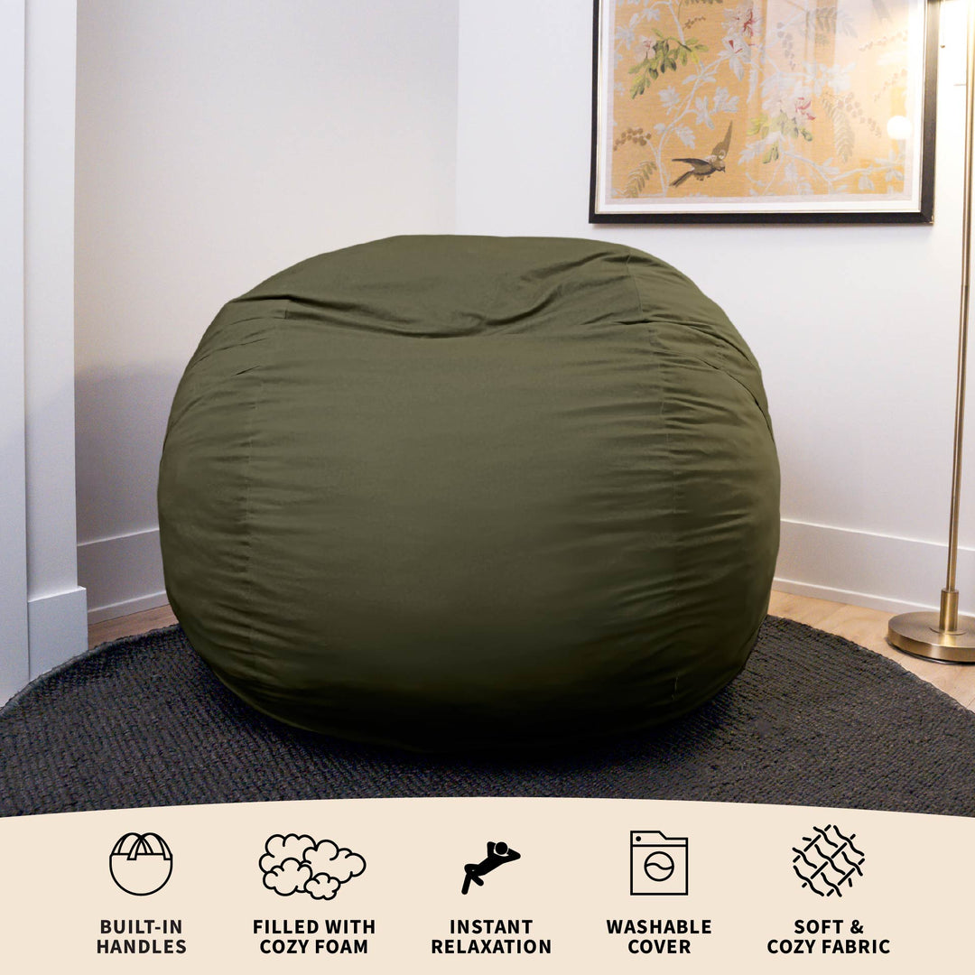 Green bean bag chair in a room with a decorative painting on the wall. #color_forest-green-velveteen